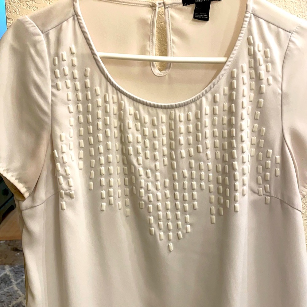 Forever 21 size small top with white shiny beads on front.